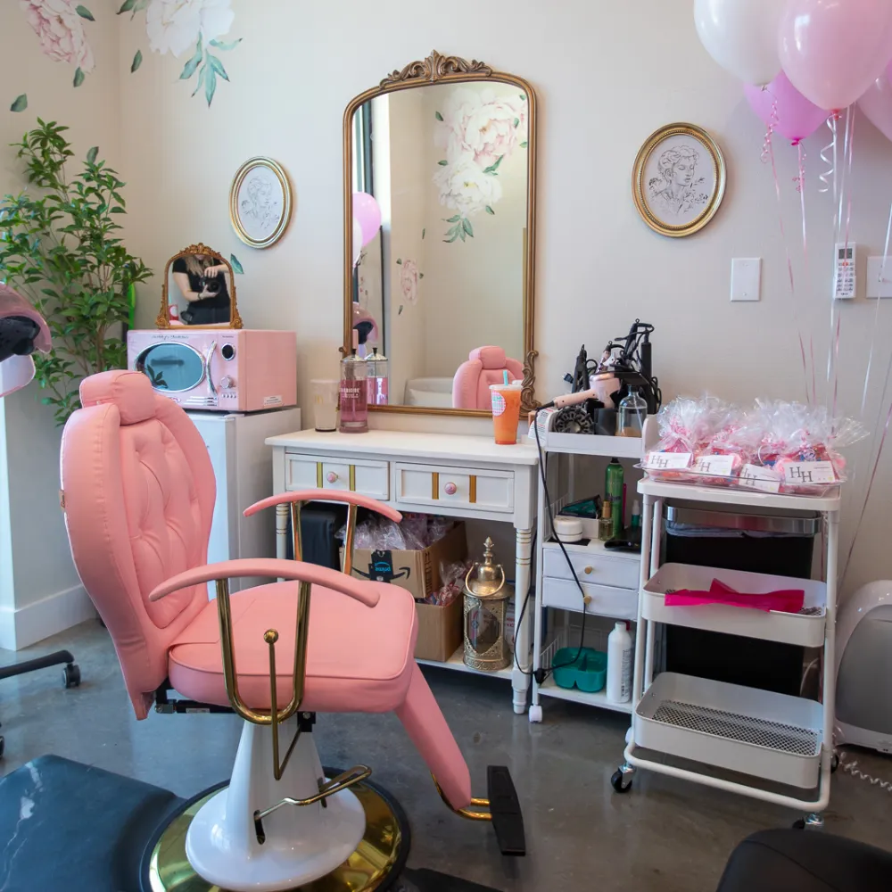Lash and beauty suite with a pink treatment chair and vanity mirror at Belle Vie The Suites in Ponchatoula, LA